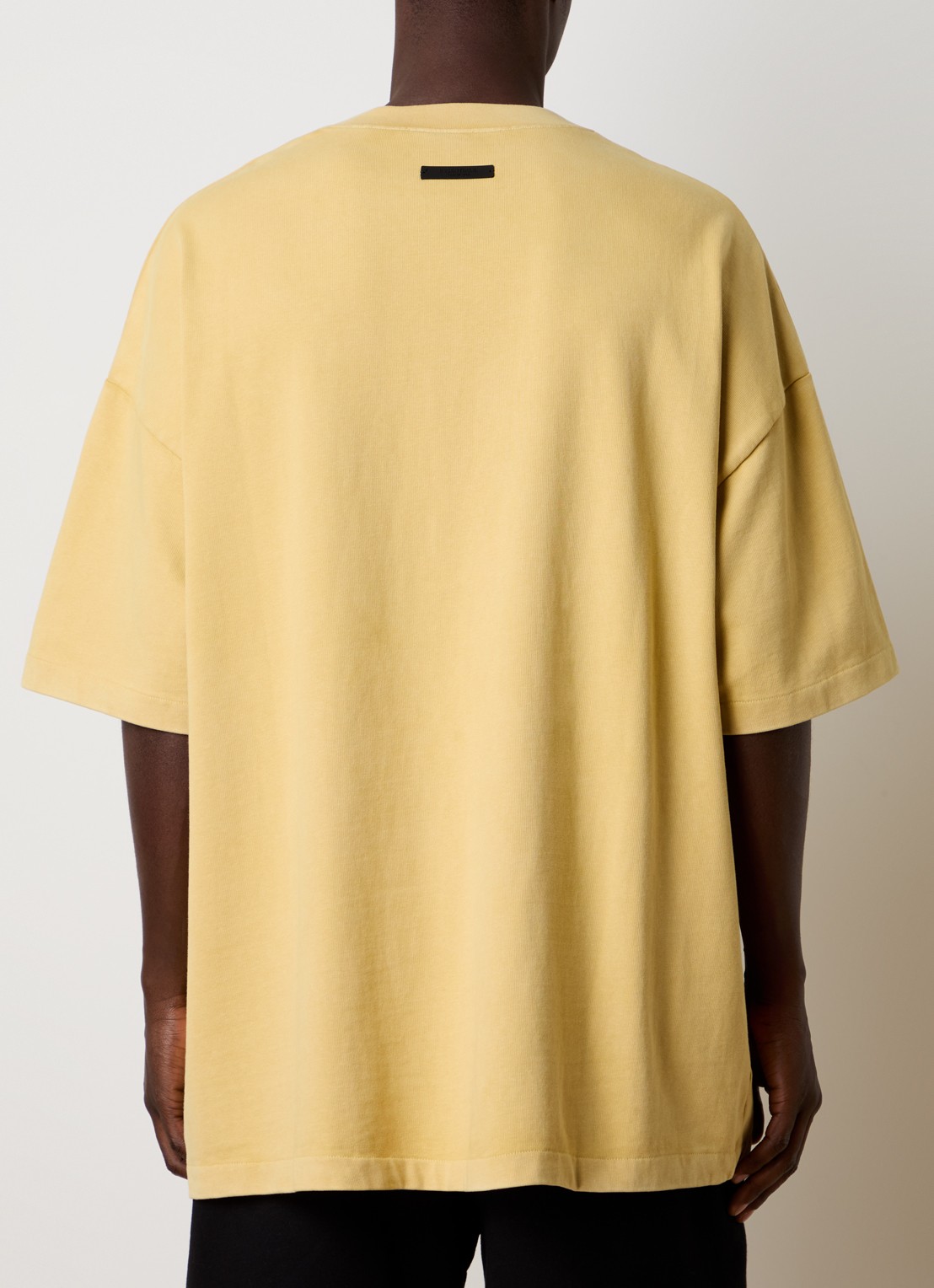 Fear of God Essentials Oversized T-shirt met logoprint - achterkant okergeel
