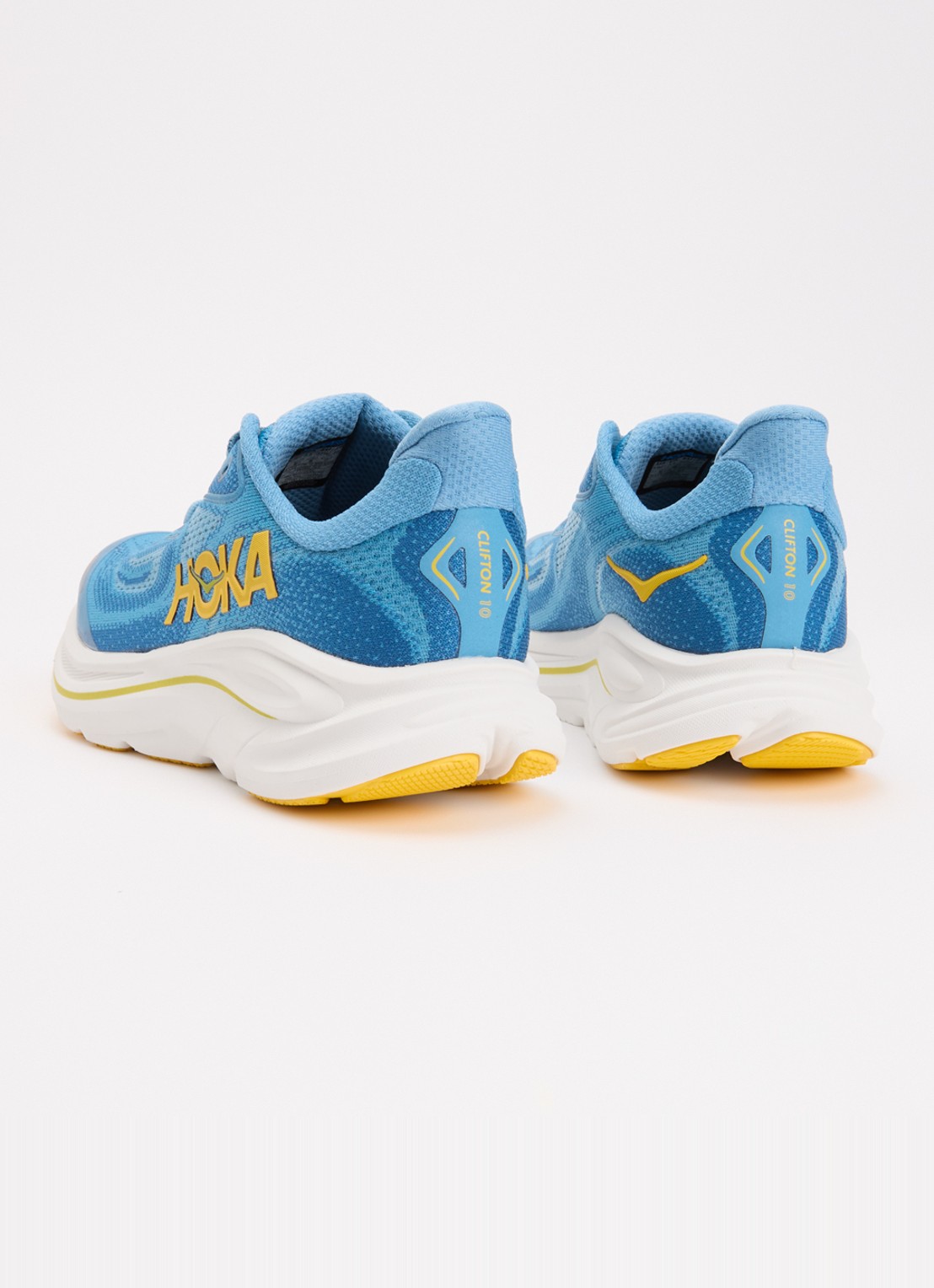 HOKA Clifton 10 hardloopschoen met gebreid bovenwerk en logo - achterkant donkerblauw