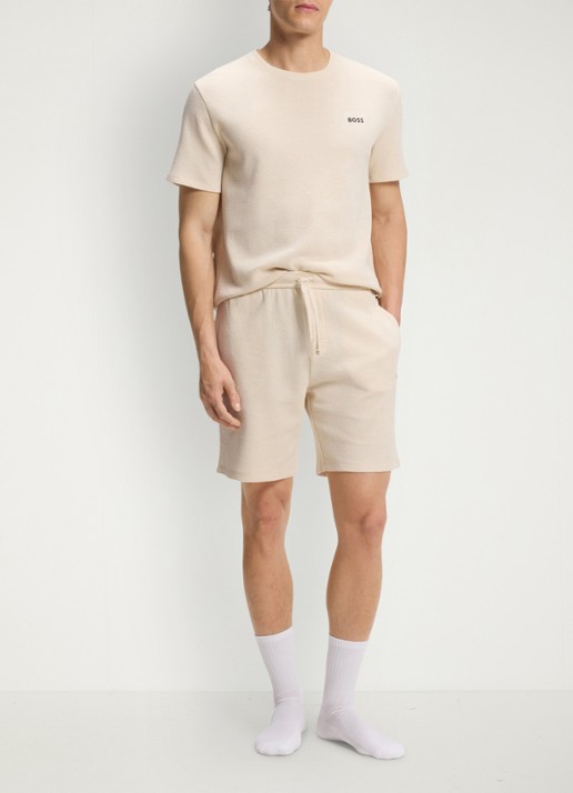 BOSS Loose fit korte broek met logo - voorkant 2 beige