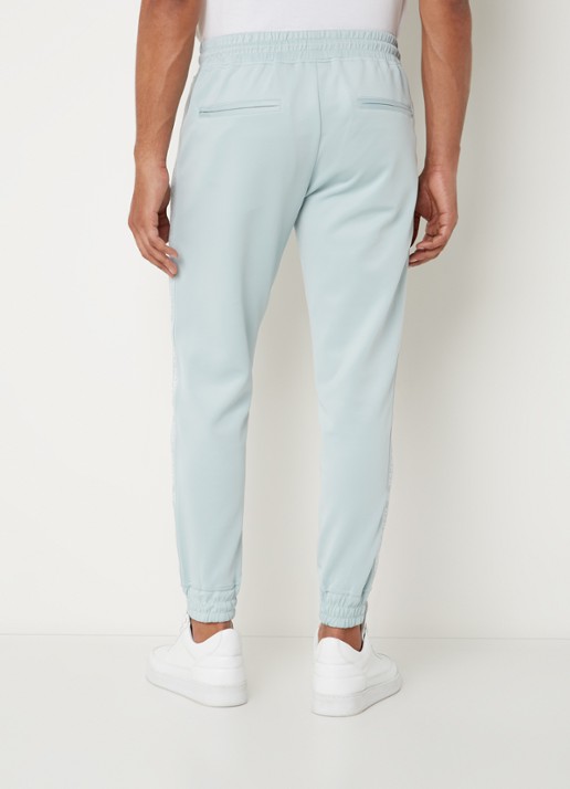 Daily Paper Etape tapered fit cropped trackpants met ritszakken en logoband - achterkant 5 mint