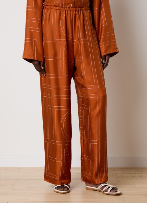 TOTEME High waist loose fit pantalon van zijde met logoborduring