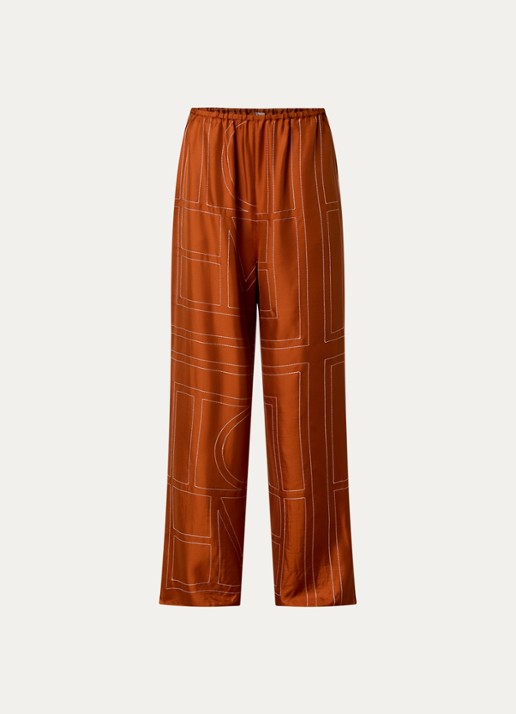 TOTEME High waist loose fit pantalon van zijde met logoborduring - voorkant oranjebruin