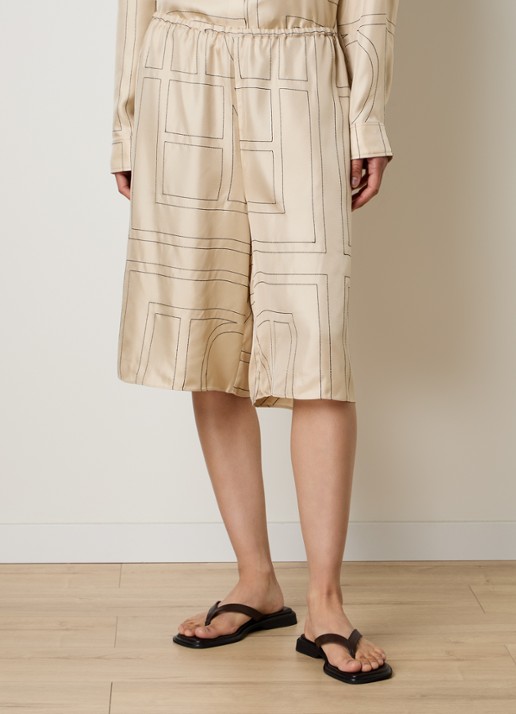 TOTEME Low waist wide fit culotte van zijde met logoprint borduring